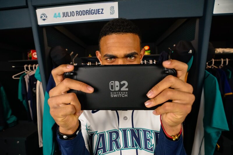 Nintendo of America teams up with the Seattle Mariners again for the 2026 season, players are shown playing Nintendo Switch 2 and their jerseys have the Nintendo logo on them